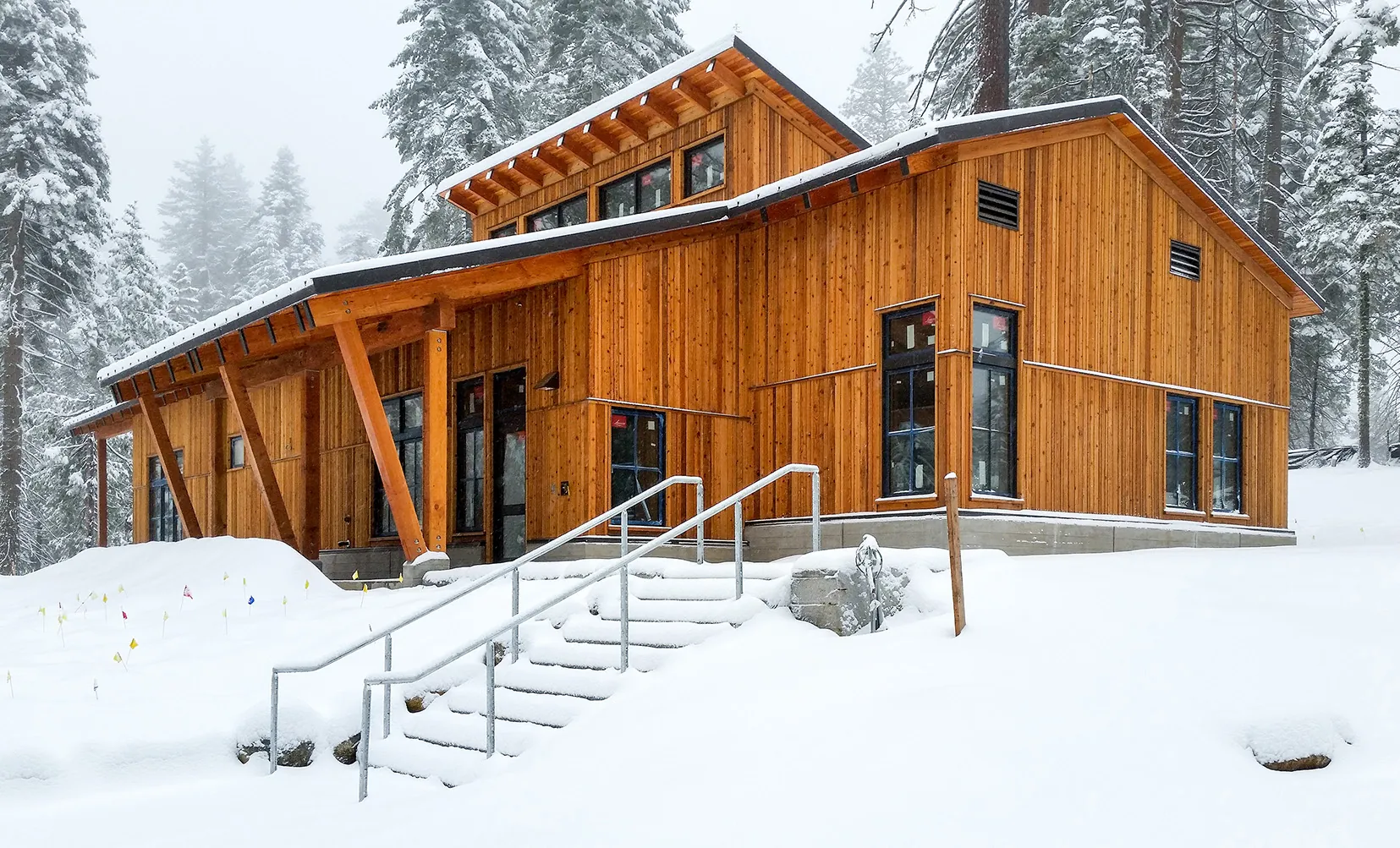 National Environmental Science Center, Yosemite National Park, California - cedar board-and-batten building under construction in fresh snow